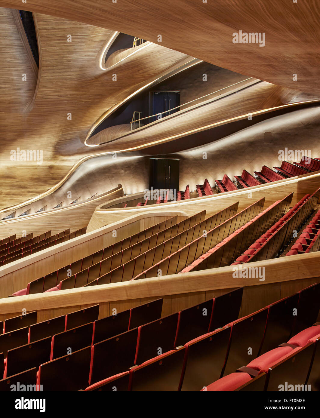 Multi-storey grand theatre interior with seating and timber sculpted wall. Harbin Opera House, Harbin, China. Architect: MAD Arc Stock Photo