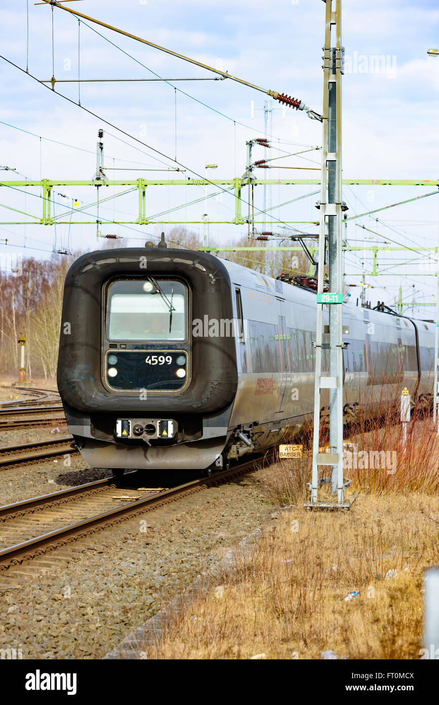 Kristianstad, Sweden - March 20, 2016: A train is just going to cross the ATC or ATP balise transponders between the rails. This Stock Photo