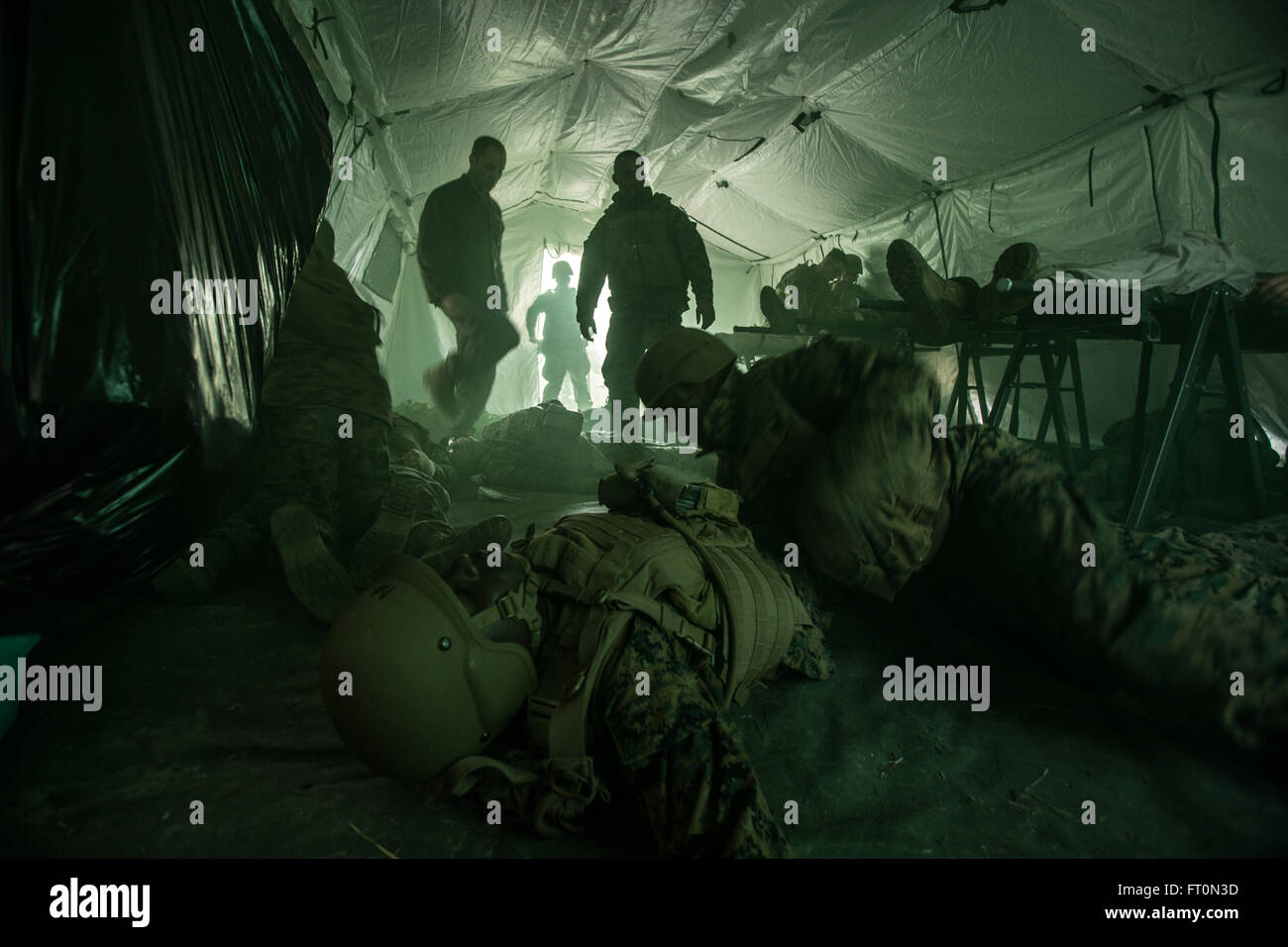 U.S. Navy Corpsmen assigned to Field Medical Training Battalion East (FMTB-E), simulate a mass casualty scenario during a final exercise (FINEX) at Camp Johnson, N.C., March 2, 2016. FINEX is a culminating event at FMTB-E which transitions Sailors into the Fleet Marine Force. (U.S. Marine Corps photo by Sgt. James R. Skelton/Released) Stock Photo