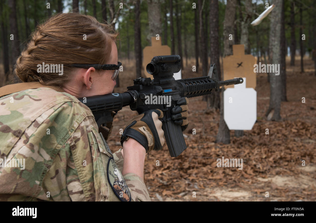 U.S. Air Force Staff Sgt. Sandra Welch, 1st Combat Camera, combat aerial photojournalist, practices firing an M4 rifle while moving sideways, during Exercise Scorpion Lens, March 5, 2016 at Fort Jackson, S.C. Exercise Scorpion Lens is an annual Ability To Survive and Operate training evolution mandated by Air Force 3N0XX Job Qualification Standards (3N0XX AFJQS).  Individuals are instructed using a 'crawl, walk, run' format of training. The exercise is twofold containing the Scorpion Lens portion, dedicated to Advanced Weapons and Tactical Training (AWTT) and the Flash Bang portion dedicated t Stock Photo