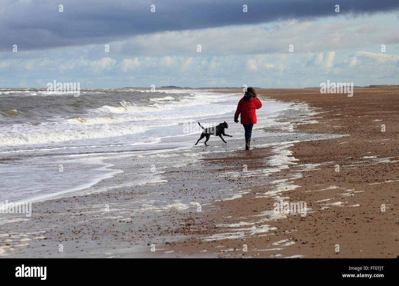 Woman alone walking on beach hi-res stock photography and images - Alamy