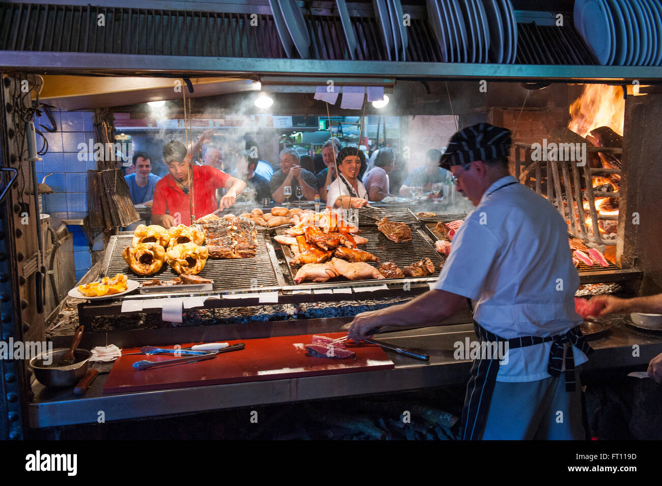 Cooks preparing steak and meat, Parilla type restaurant, Mercado del Puerto, Montevideo, Montevideo, Uruguay Stock Photo