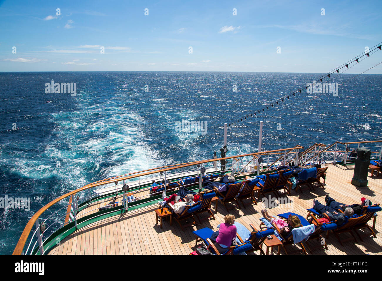 Passengers relaxing on the deck of cruise ship MS Deutschland Reederei Peter Deilmann, Atlantic Ocean, near Portugal Stock Photo