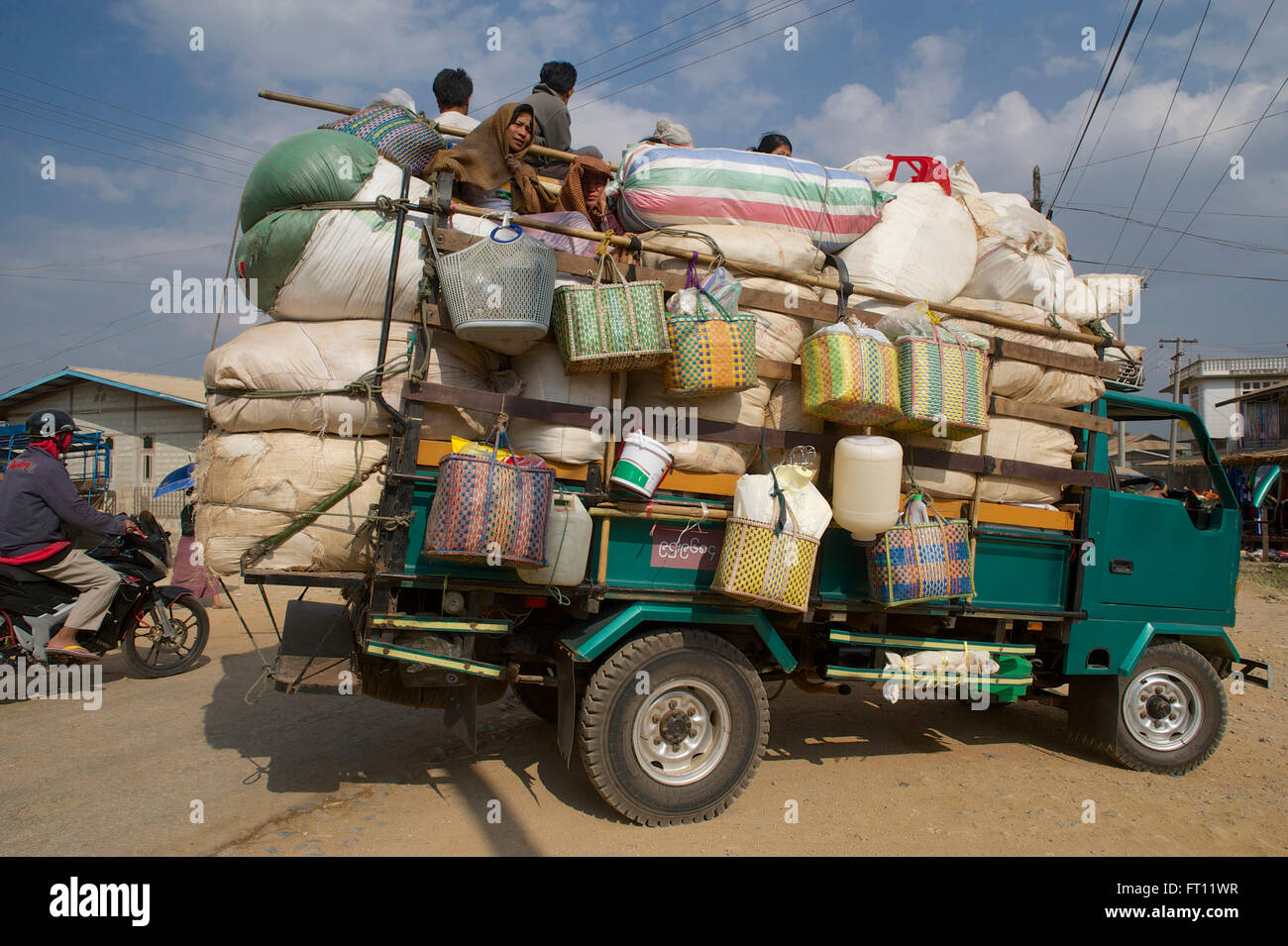 Overloaded Truck with passengers on the top at a market south of Inle ...