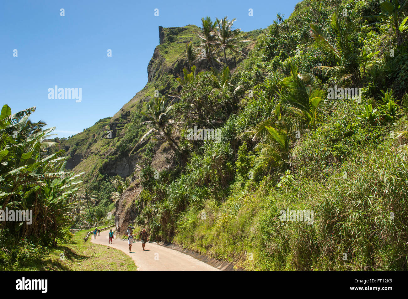 People walking on a pathway through a tropical forest, Pitcairn, Pitcairn Group of Islands, British Overseas Territory, South Pacific Stock Photo