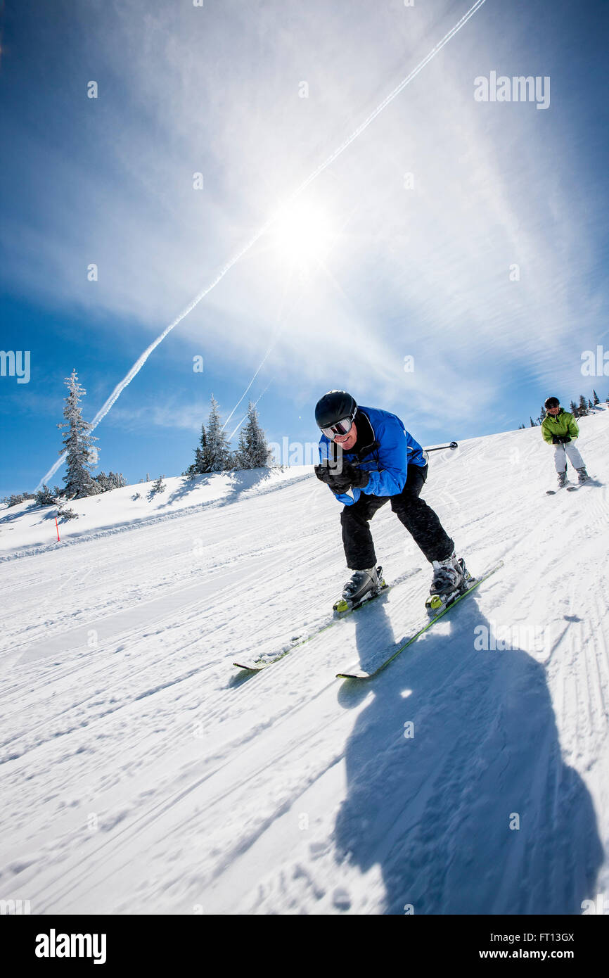 Two skiers downhill skiing, Fageralm, Salzburg, Austria Stock Photo