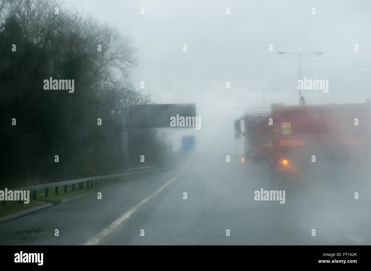 Dangerous and wet driving conditions on the road Stock Photo