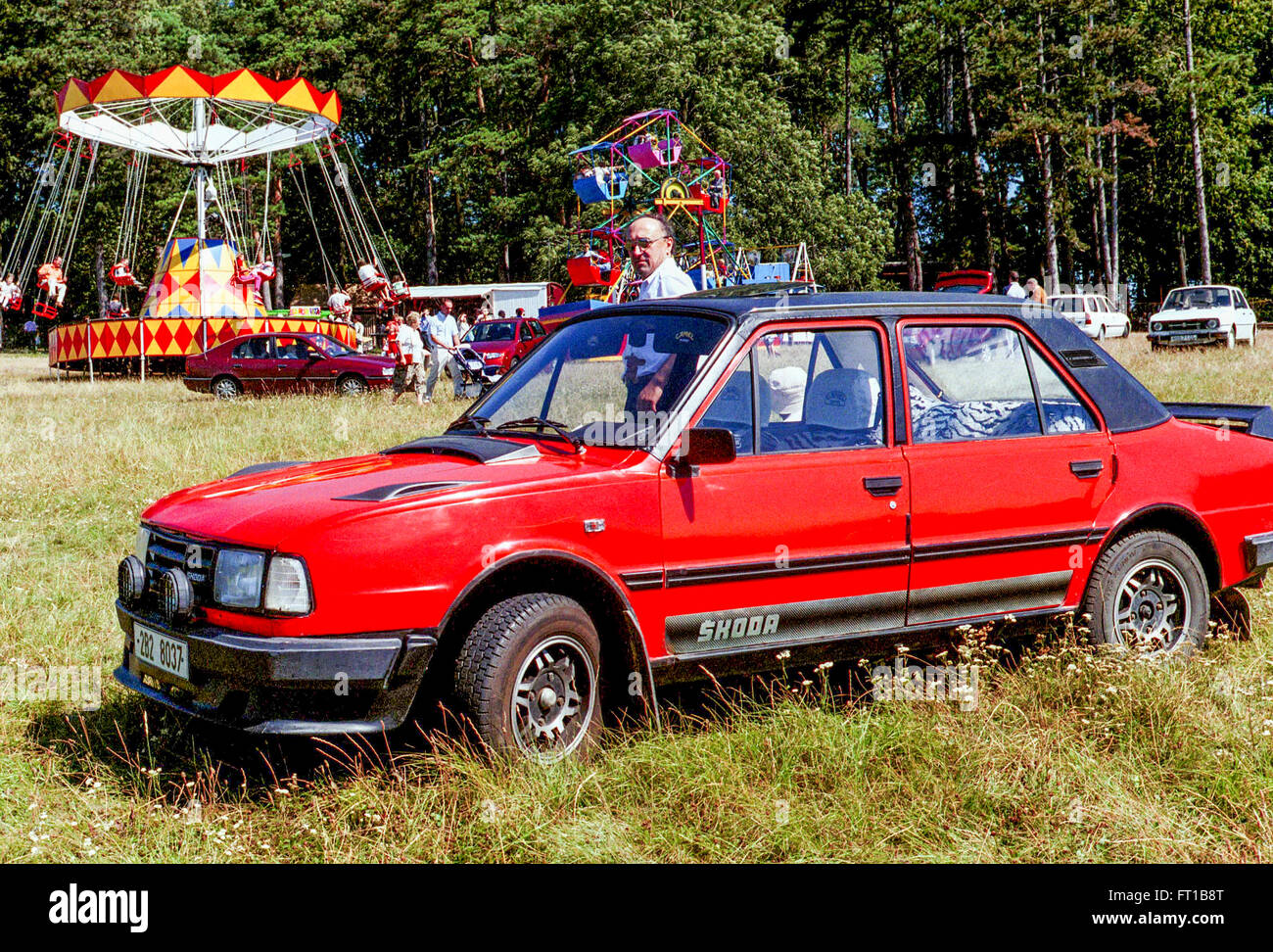 Czechoslovakia product from the 1980s Red car Skoda 120 parking on the meadow during a village fair, Moravia Czech Republic Stock Photo