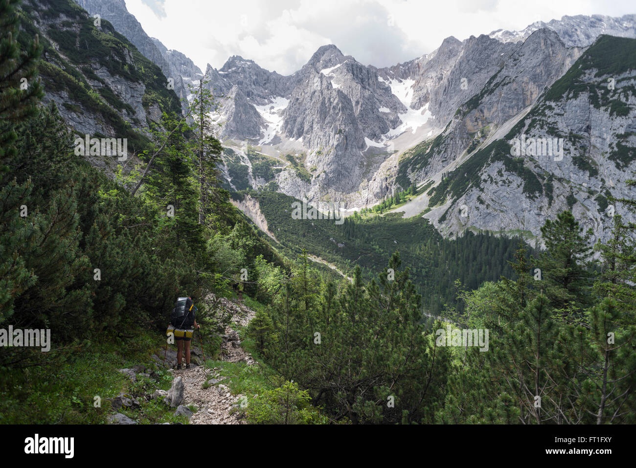 Female hiker on the descent from Mount Schachen into the Oberrein valley at the Wetterstein mountains, Bavaria, Germany Stock Photo
