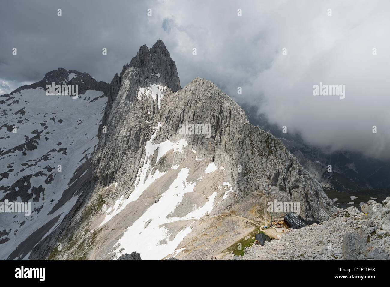 Sunshine and clouds above the Meilerhuette mountain hut and Mount Partenkirchner Dreitorspitze in the Wetterstein mountain range Stock Photo