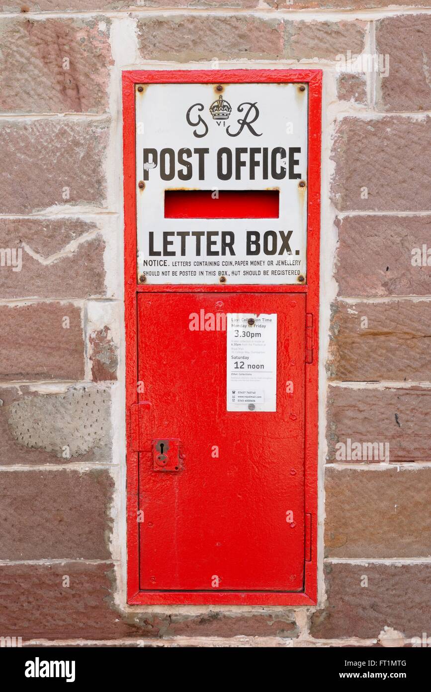 GR vi (six) wall mounted post office letter box in British red colouring at the general store in Luss, Scotland, UK Stock Photo