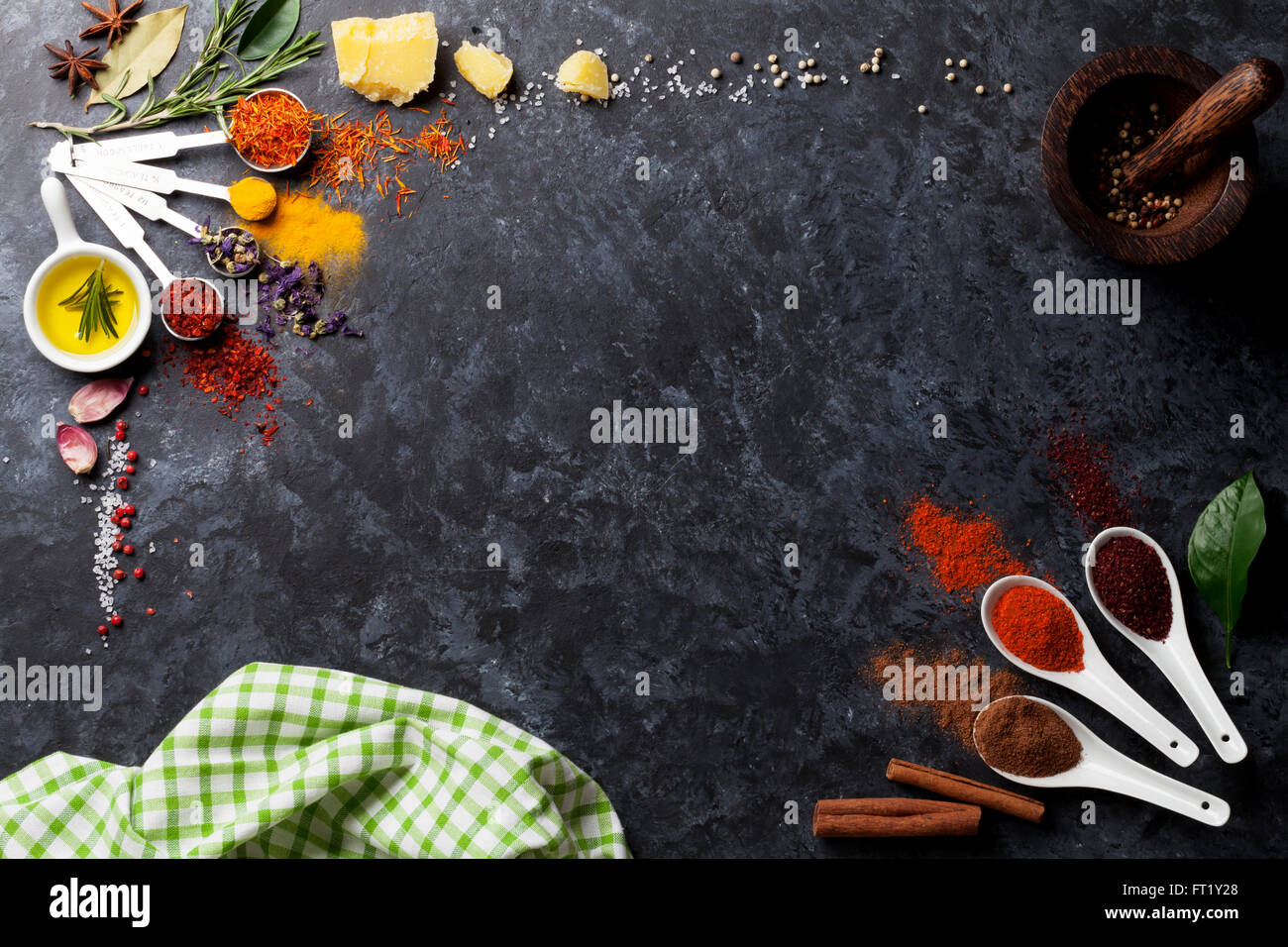 Herbs and spices over black stone background. Top view with copy space
