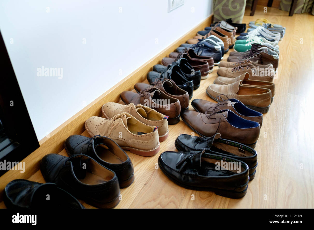 Row of mens shoes lined up on the floor Stock Photo