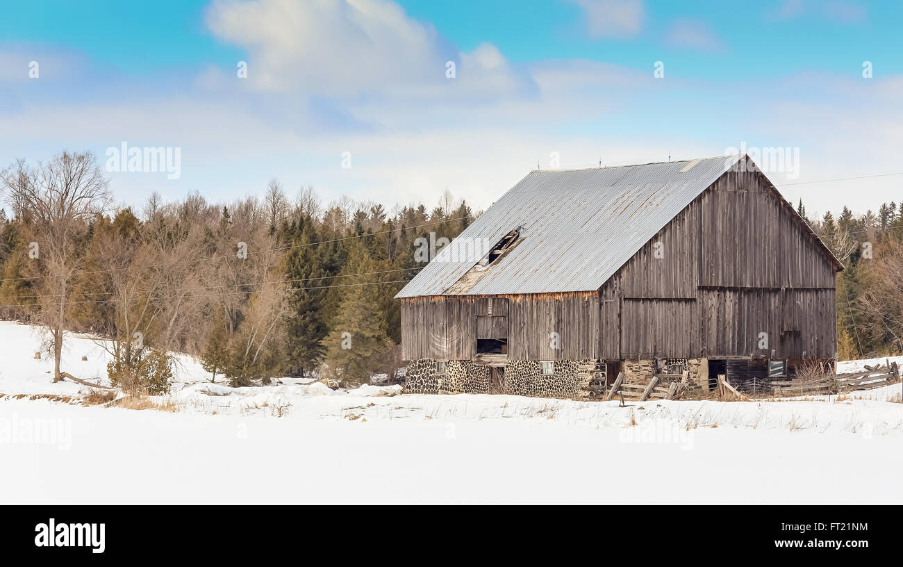 Old Decrepit Barn in winter landscape Stock Photo