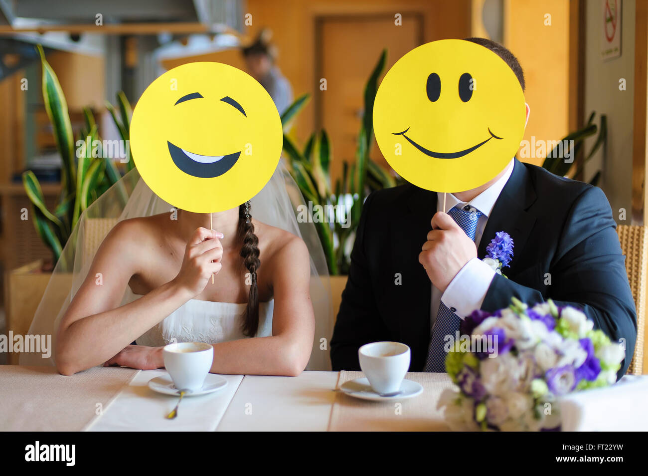 bride and groom with Smiley face cutouts Stock Photo - Alamy