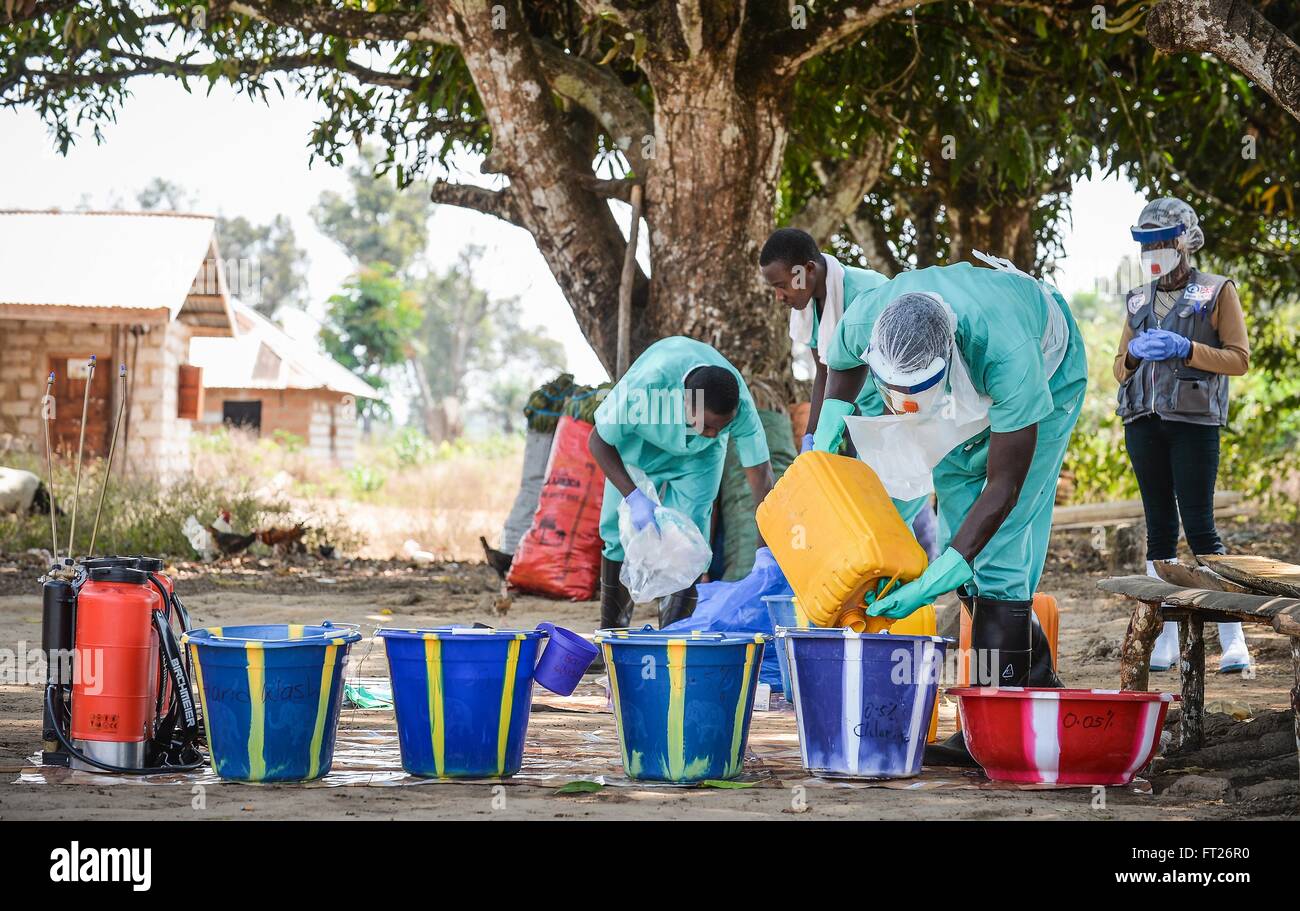 A medical team member prepares chlorinated water for decontamination of a victim of the Ebola virus February 10, 2015 in Port Loko District, Sierra Leone. Stock Photo