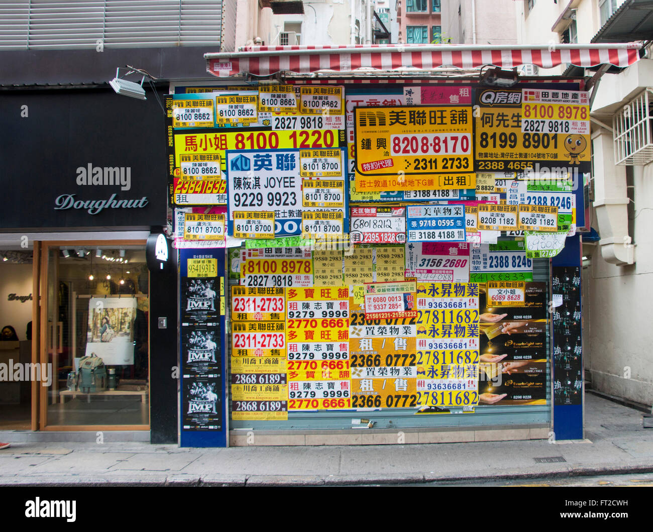 Renting Estate agent kiosk advertising telephone numbers in Hong Kong Stock Photo