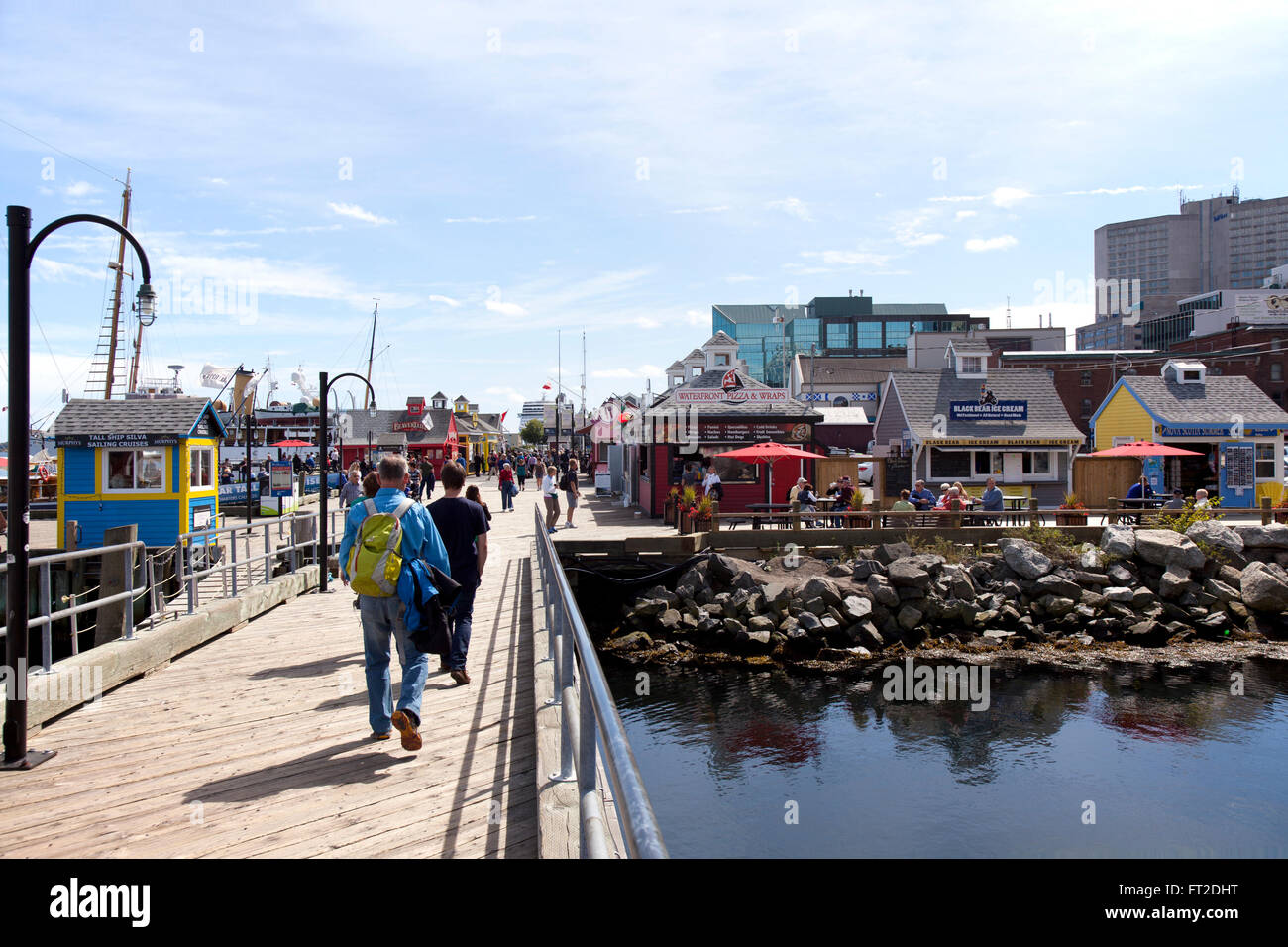 Tourists walking along the Waterfront boardwalk in Halifax , Nova Scotia Stock Photo