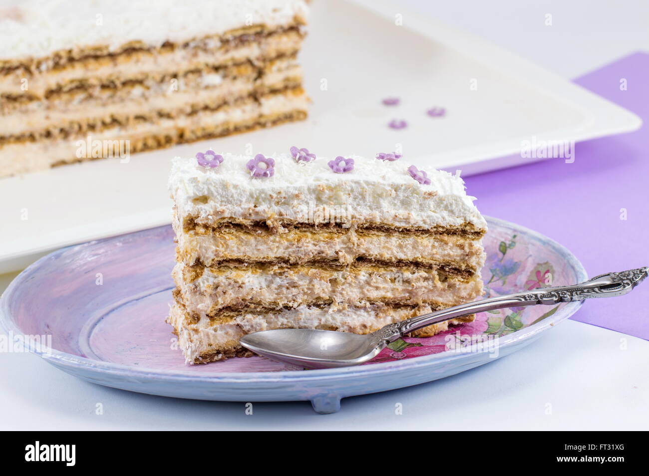 Slice of homemade cake made out of piled biscuits on a plate Stock Photo