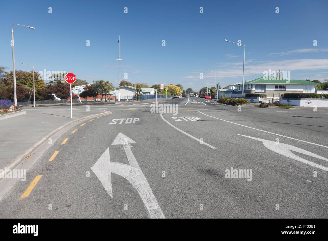 White arrows painted on road at STOP junction, cross road in Timaru,Canterbury,South Island,New Zealand Stock Photo