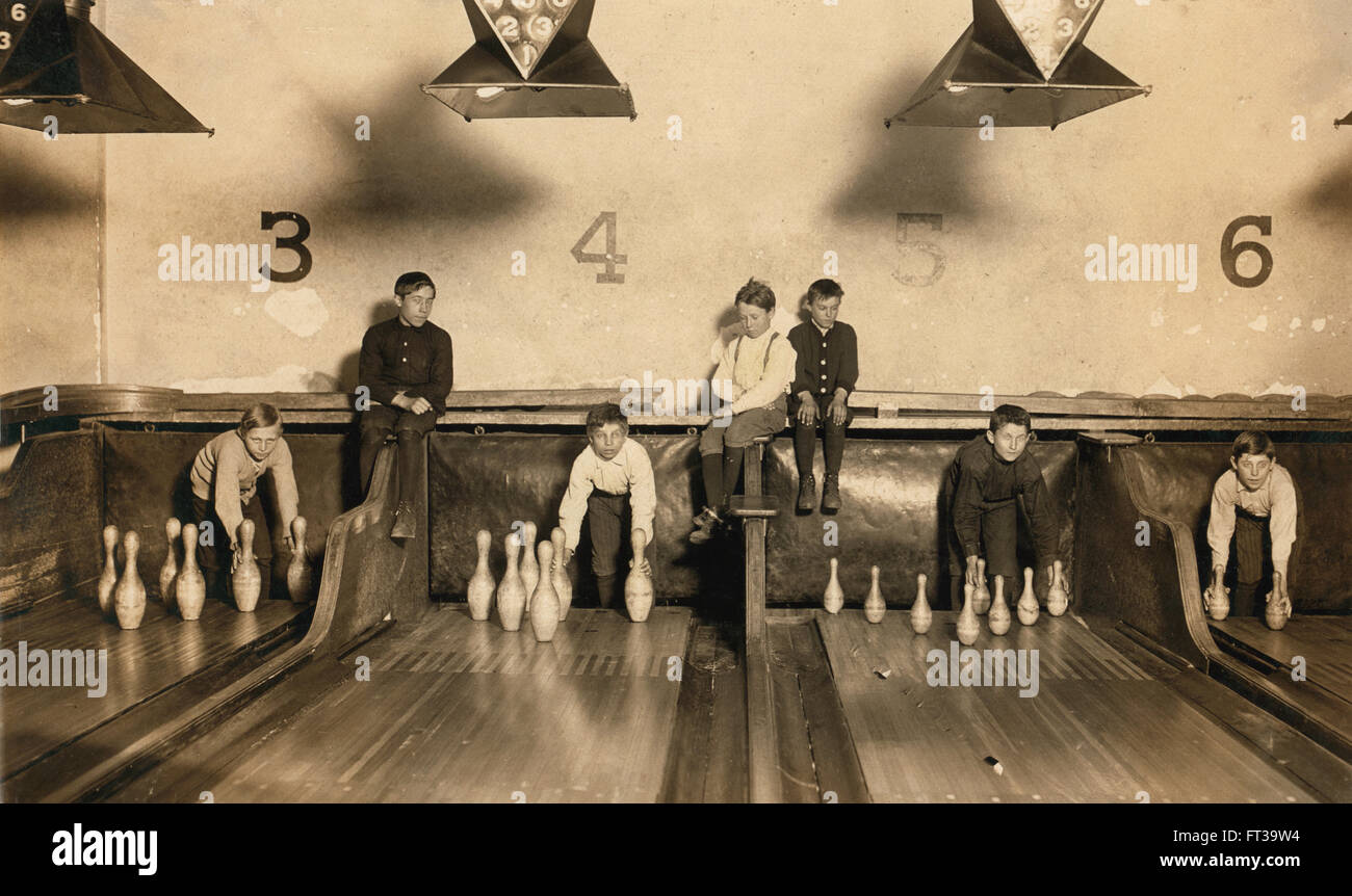 Young Boys Setting Up Bowling Pins at Arcade Bowling Alley Late at