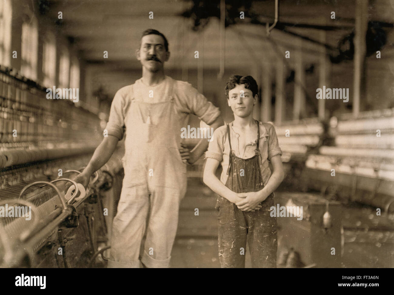 Portrait of Mule Spinner and Young Assistant at Cotton Mill, Burlington, Vermont, USA, circa 1909 Stock Photo