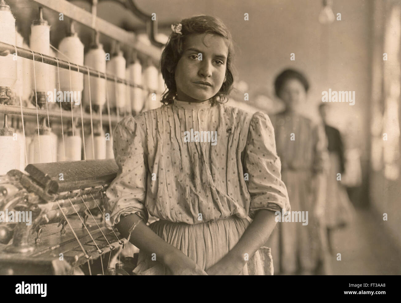 Portrait of Teen Girl Working as Spinner at Cotton Mill, Lancaster, South Carolina, USA, circa 1908 Stock Photo