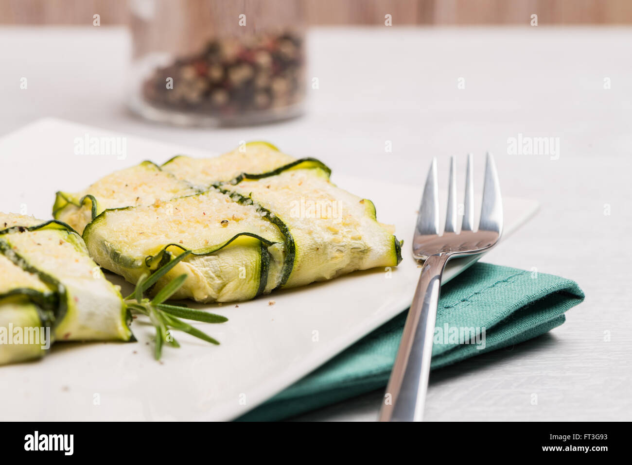 Interlaced courgettes or zucchini slices and meat with grated cheese ready to be eaten Stock Photo