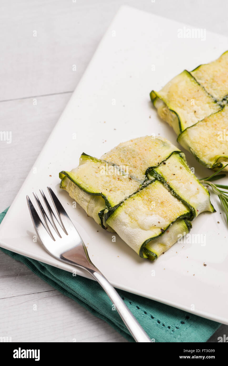 Interlaced courgettes or zucchini slices and meat with grated cheese ready to be eaten Stock Photo