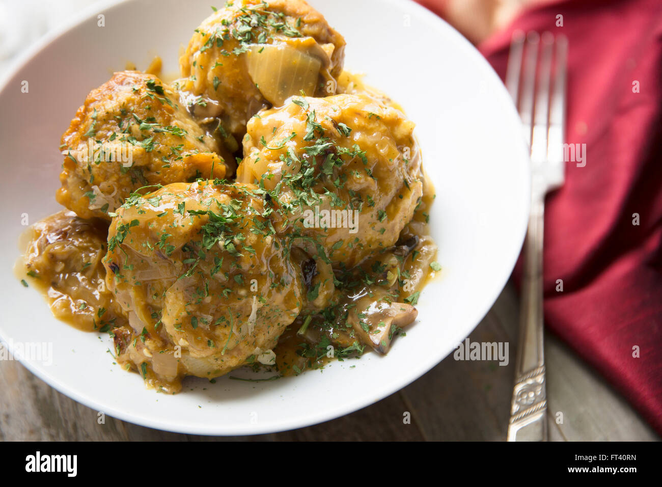 Fresh Bavarian bread dumplings with mushroom gravy sauce. Stock Photo