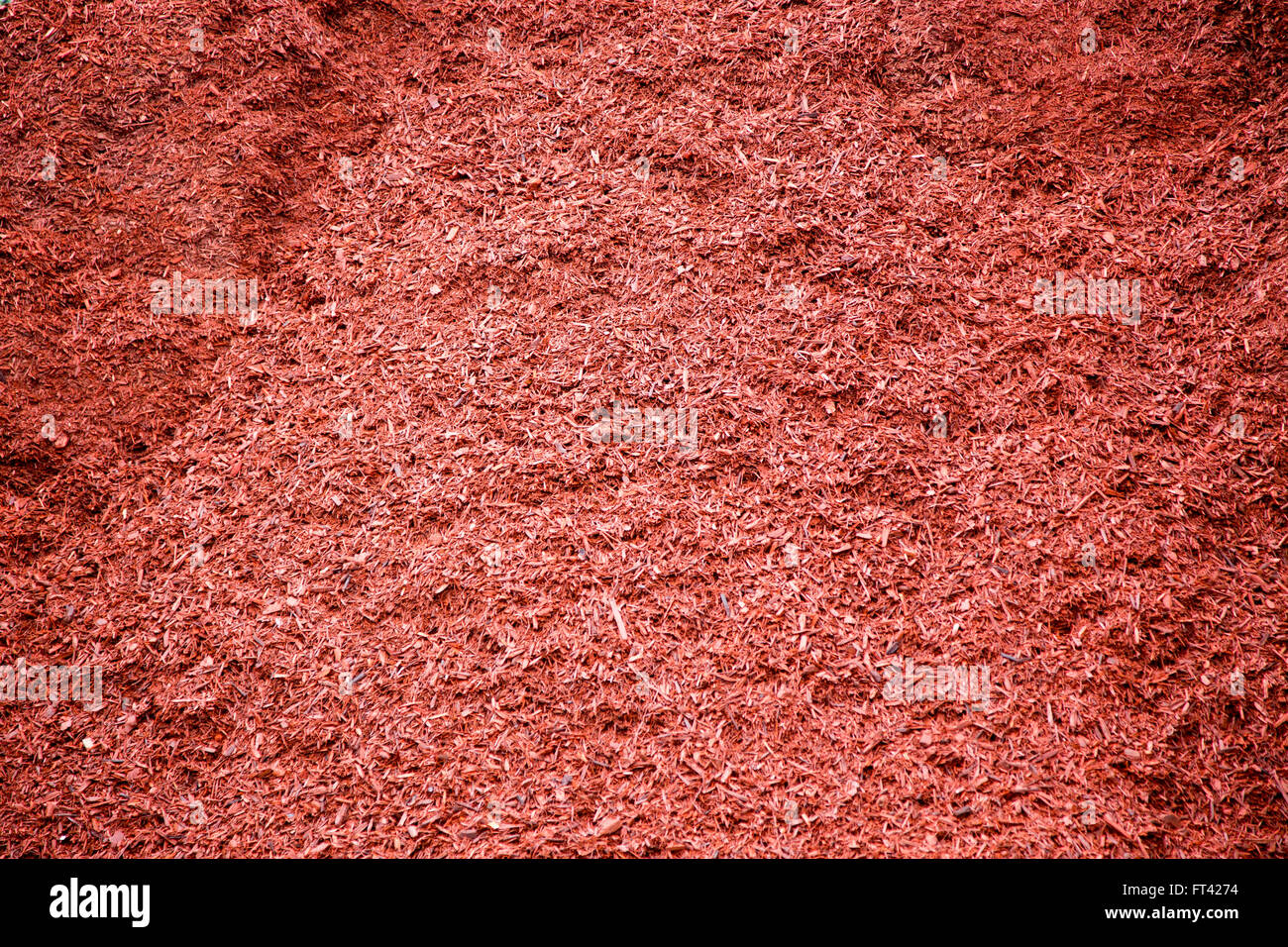 Red dyed cedar mulch in a large pile for landscaping at garden centre