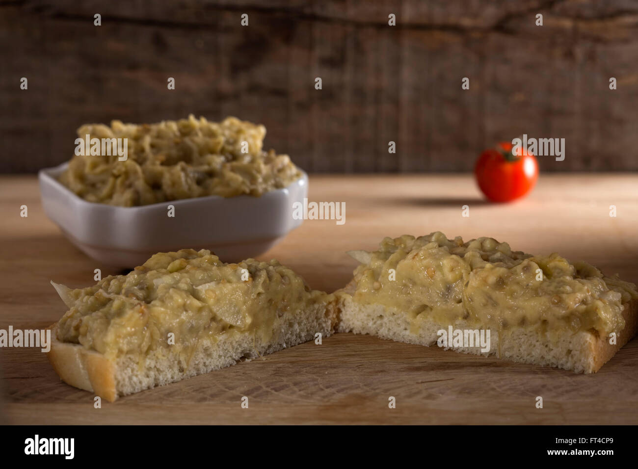 Slice of bread with eggplant salad with mayonnaise and one cherry