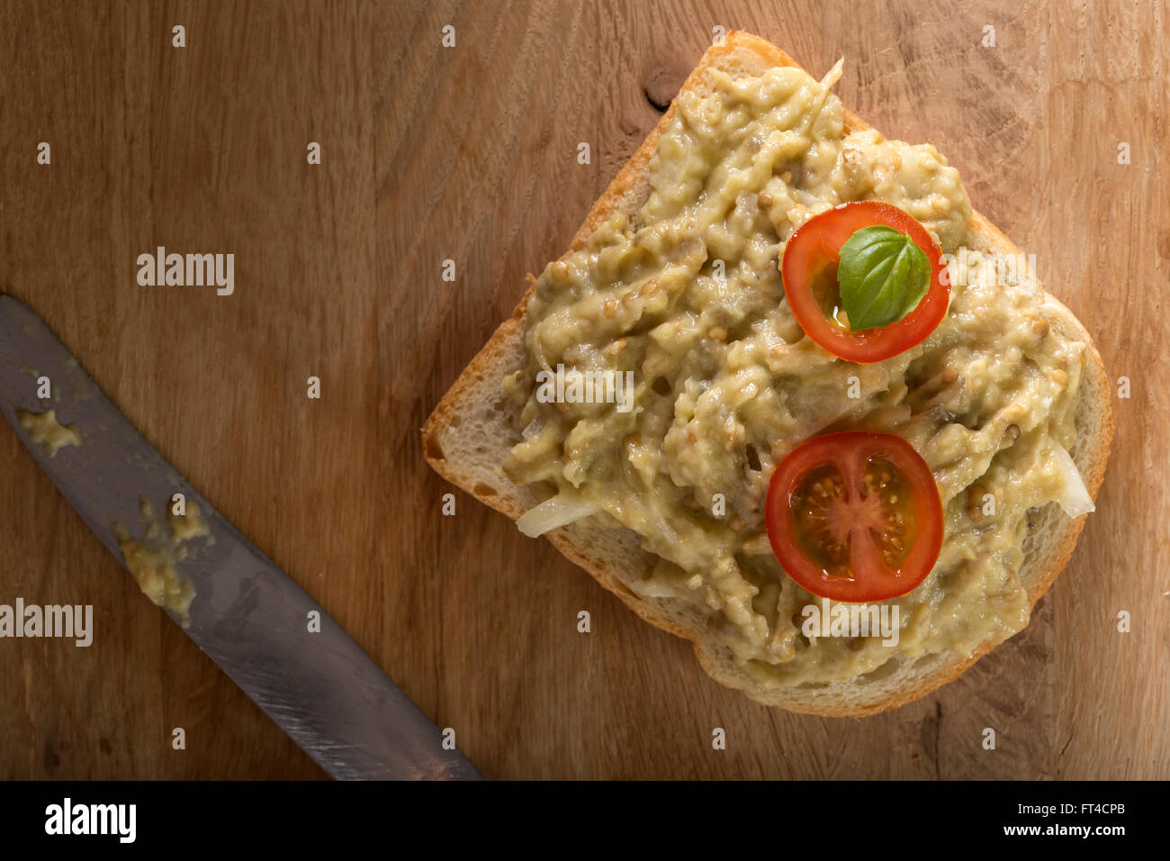Slice of bread smeared with eggplant salad Stock Photo