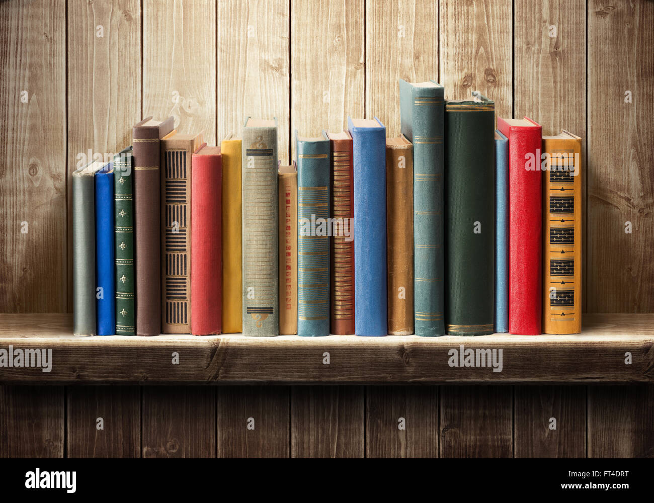 Old books on wooden shelf Stock Photo
