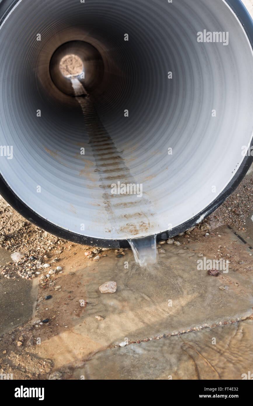 Water runs through plastic drainage pipe Stock Photo Alamy