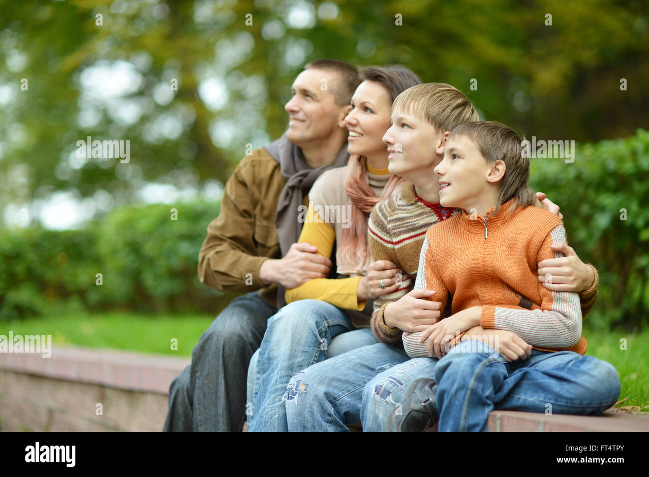 Happy family of four Stock Photo - Alamy