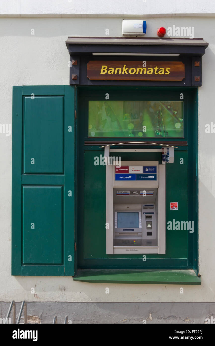VILNIUS, LITHUANIA - MAY 04, 2013: The street ATM  is built in in a simple wooden window of DNB  bank. In Norway, DNB has more t Stock Photo