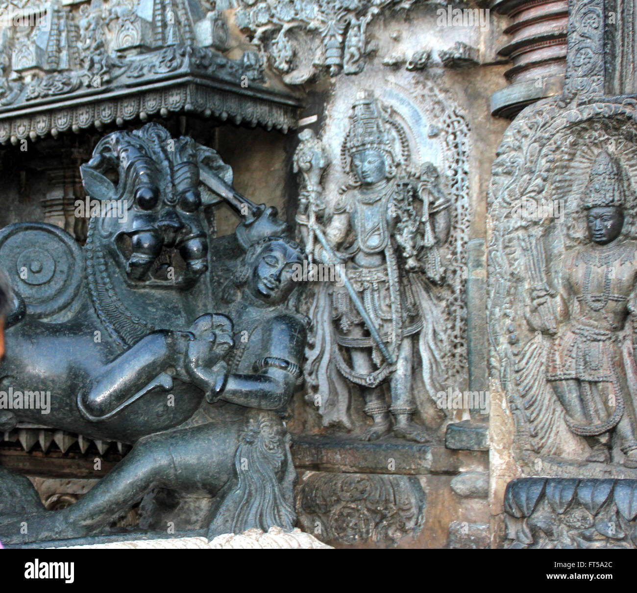 Stone carved human and animal figures on outer walls of Chennakesava Temple in Belur, Karnataka Stock Photo