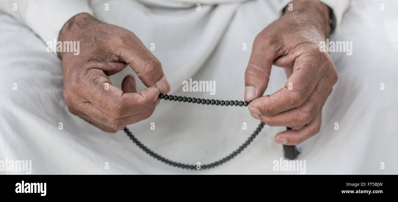 Old muslim Man with rosary praying Stock Photo