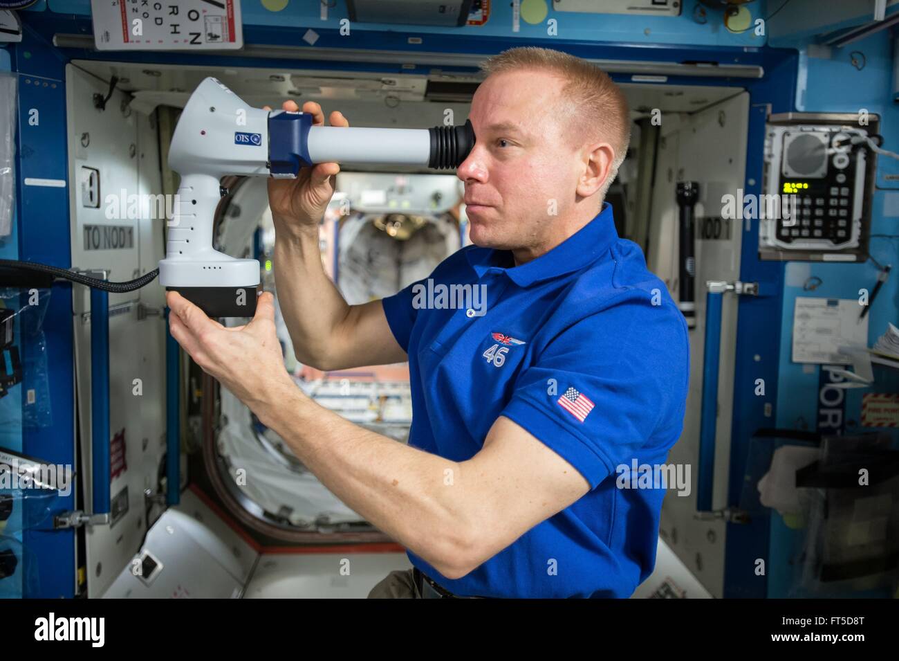 NASA astronaut Tim Kopra participates in the Ocular Health investigation aboard the International Space Station March 16, 2016 in Earth Orbit. The study seeks to better understand how weightlessness effects vision. Stock Photo