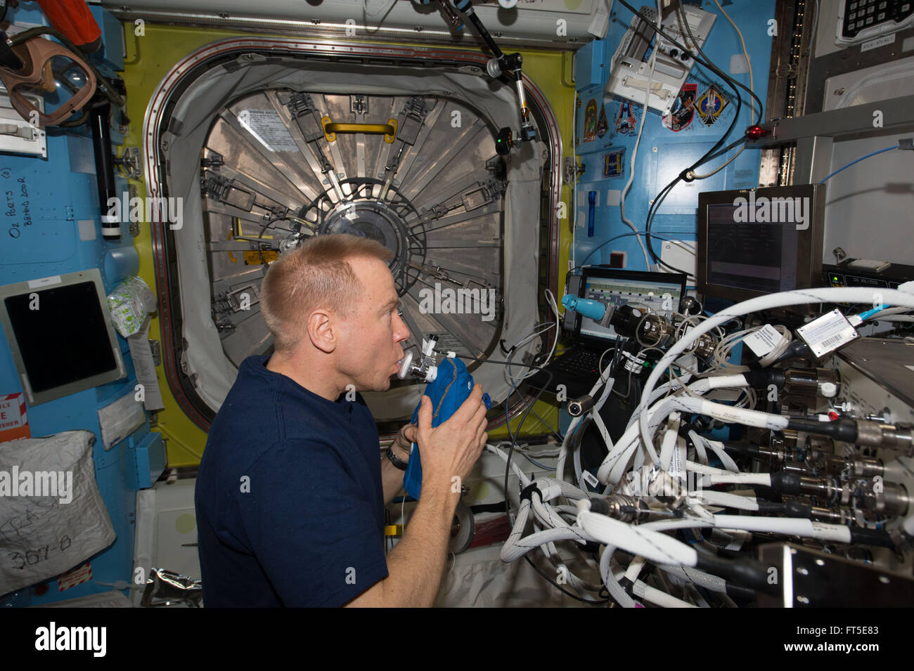 American astronaut Tim Kopra participates in the Airway Monitoring experiment aboard the International Space Station February 25, 2016 in Earth Orbit. The Airway Monitoring studies the occurrence and indicators of airway inflammation in crewmembers, using ultra-sensitive gas analyzers to analyze exhaled air. Stock Photo