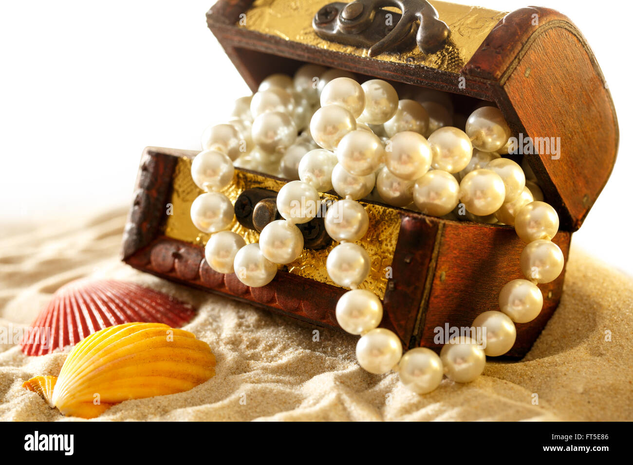 Treasure chest with seashells and pearl on sand Stock Photo Alamy