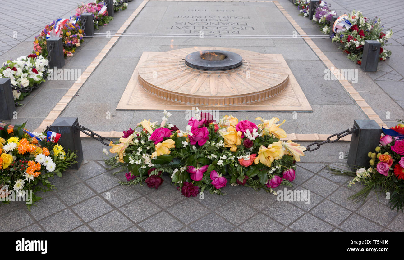 Arc de Triomphe memorial and flame for unknown soldier with many flower wreaths Stock Photo