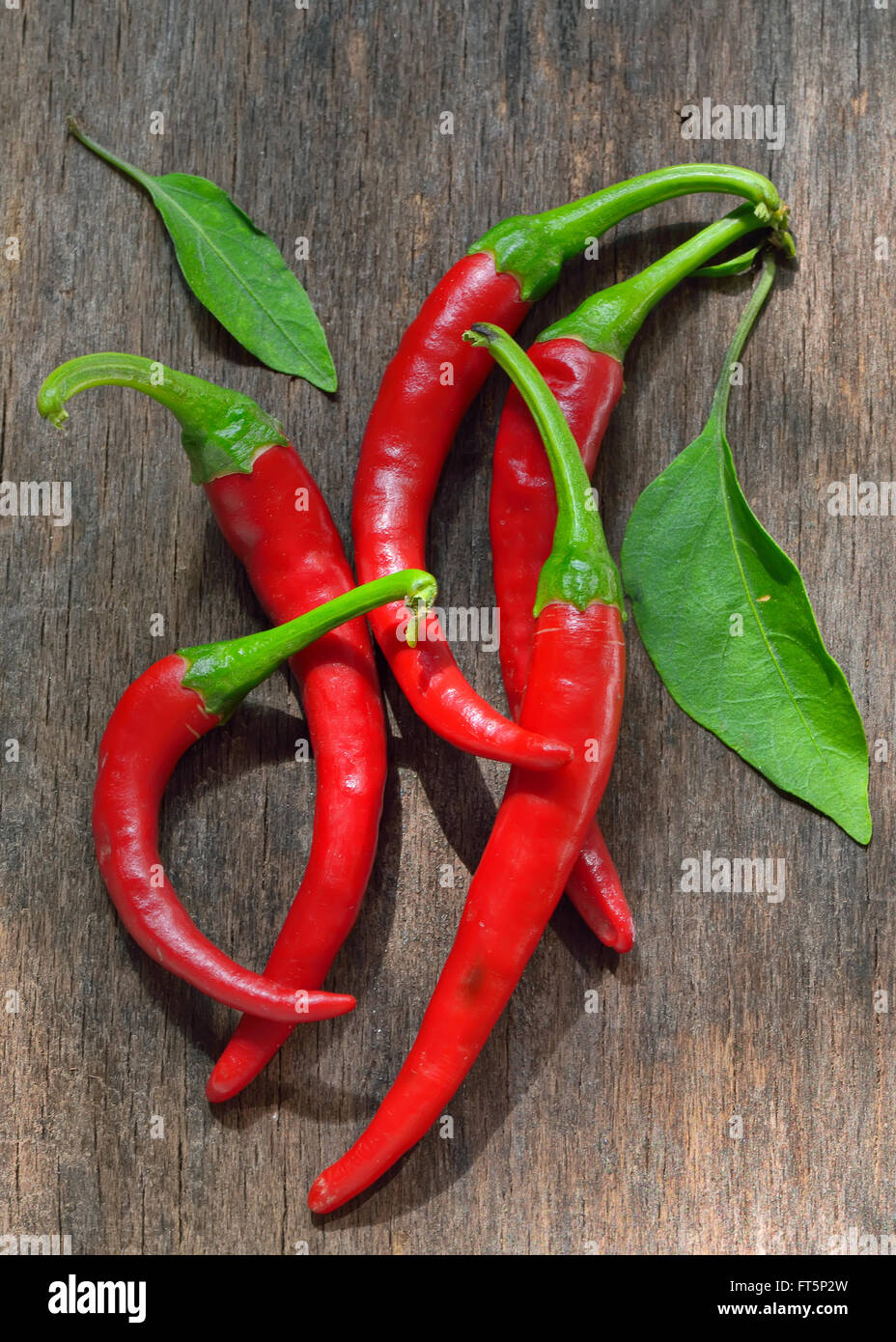 Red Chili Peppers over wooden background Stock Photo