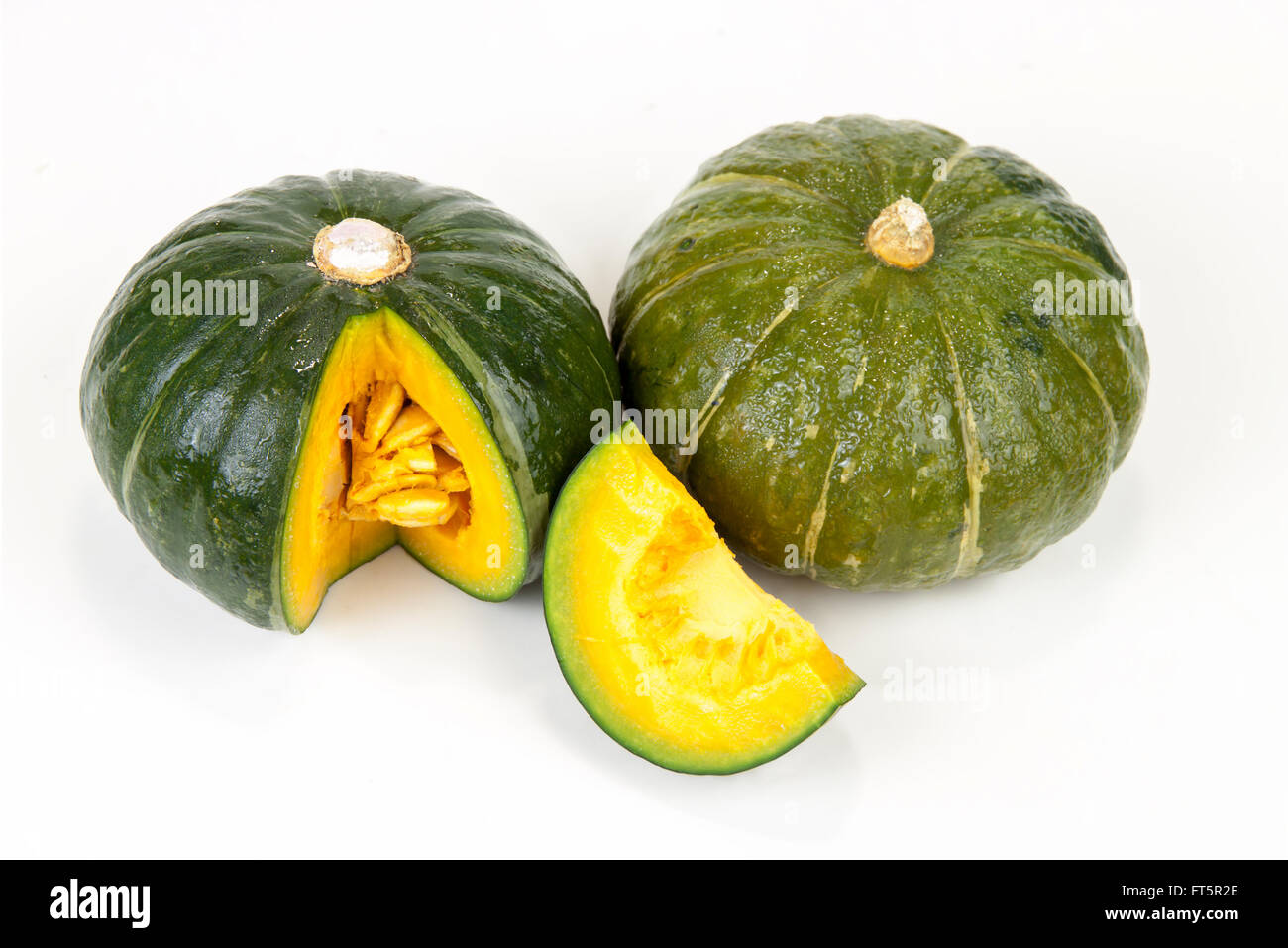 Fresh Green Japanese Pumpkin sliced on isolated white background with clipping paths Stock Photo