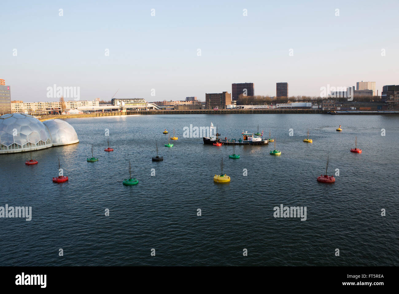 A ship attends buoys at the Bobbing Forest in Rotterdam, the Netherlands. The forest at the Rijnhaven features 20 sea buoys. Stock Photo