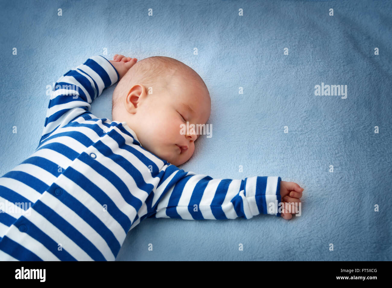 Baby sleeping in bed Stock Photo - Alamy