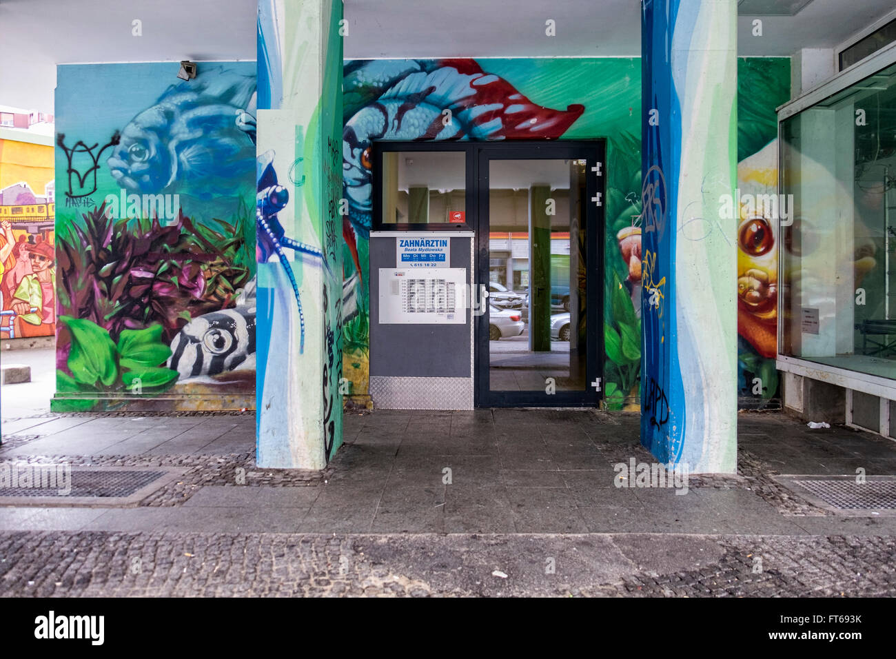 Berlin Kreuzberg Street art. Entrance to dental practice with mural art and graffiti Stock Photo