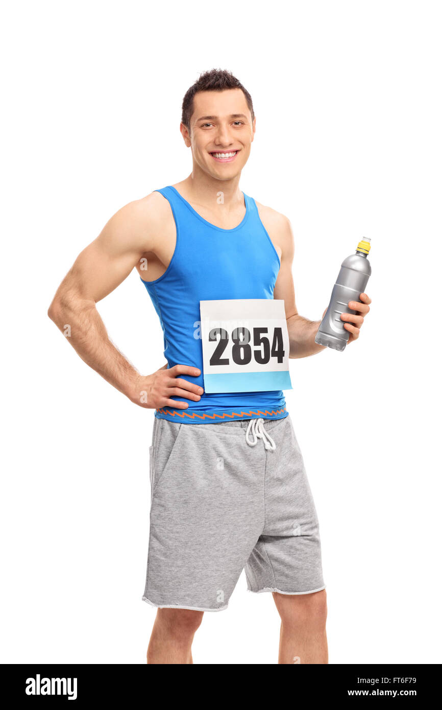 Vertical shot of a young male runner athlete holding a water bottle and looking at the camera isolated on white background Stock Photo