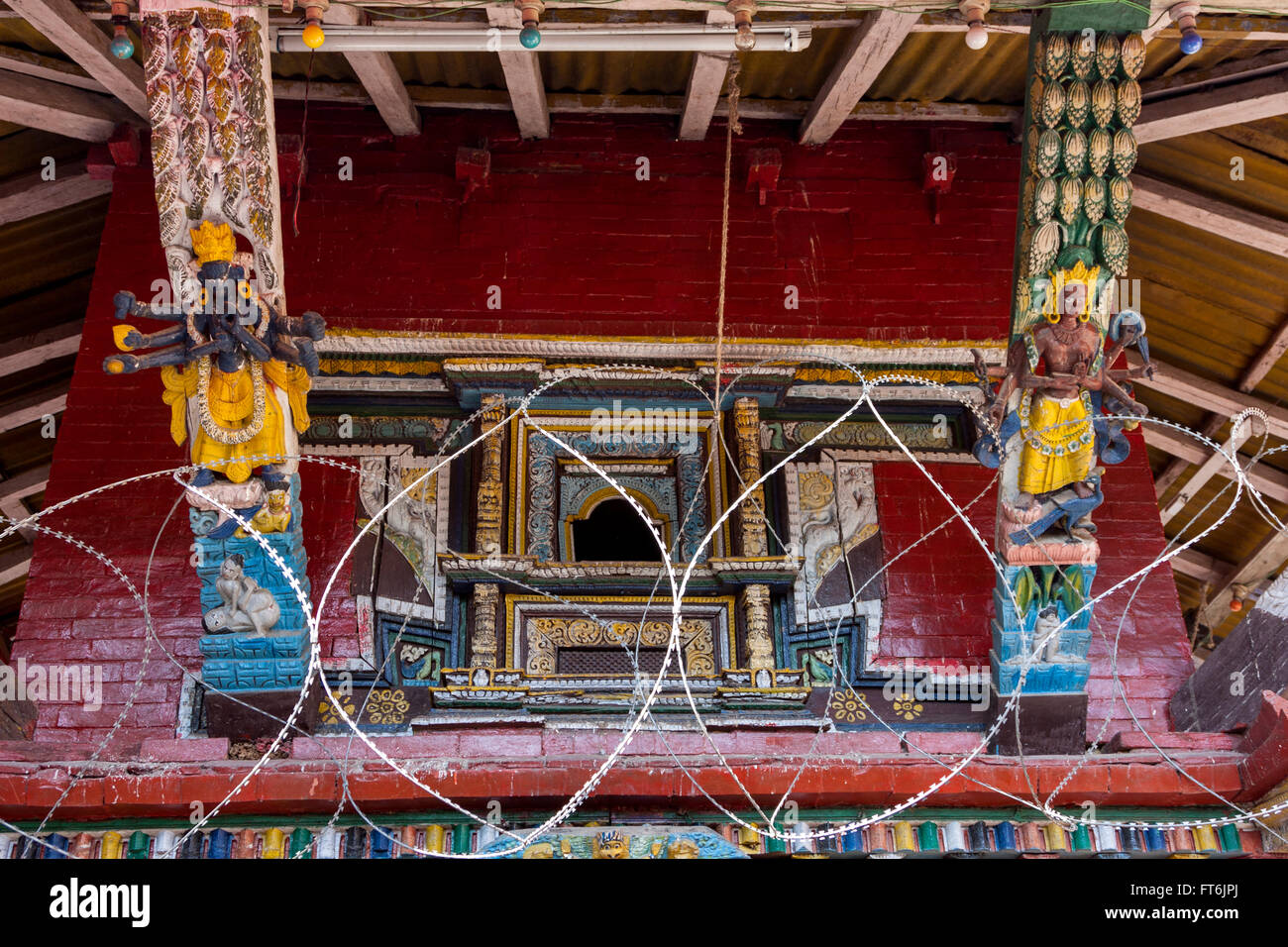 Nepal, Kathmandu.  Temple Carvings Dedicated to Shiva and Parvati, Razor Wire to Prevent Theft. Stock Photo